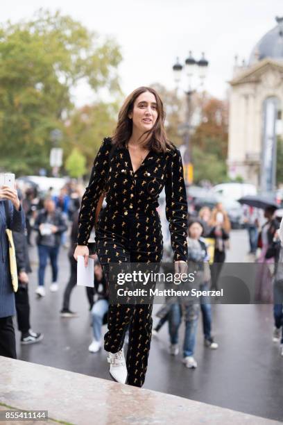 Guest is seen attending Paco Rabanne during Paris Fashion Week wearing a black and gold jumpsuit on September 28, 2017 in Paris, France.