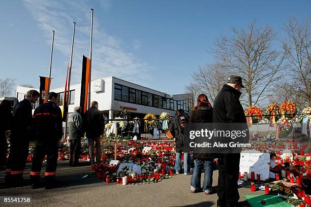 Mourners stand in front of flowers and candles outside Albertville high school on March 21, 2009 in Winnenden near Stuttgart, Germany. 17 year old...