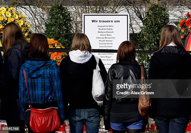 Mourners stand in front of a sign with the names of the victims outside Albertville high school on March 21, 2009 in Winnenden near Stuttgart,...