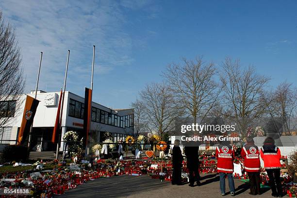 Mourners stand in front of flowers and candles outside Albertville high school on March 21, 2009 in Winnenden near Stuttgart, Germany. 17 year old...