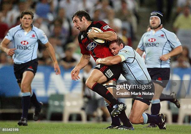 George Whitelock of the Crusaders is tackled by Phil Waugh of the Waratahs during the round six Super 14 match between the Waratahs and the Crusaders...