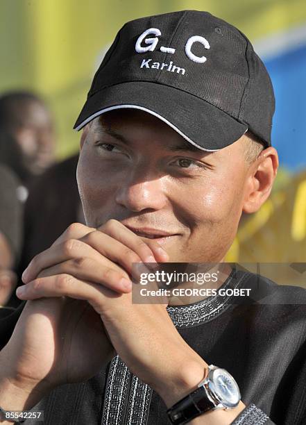 Karim Wade, son of Senegal president Abdoulaye Wade listens to his father speak at a local election meeting in Dakar on March 20, 2009. Senegal's...