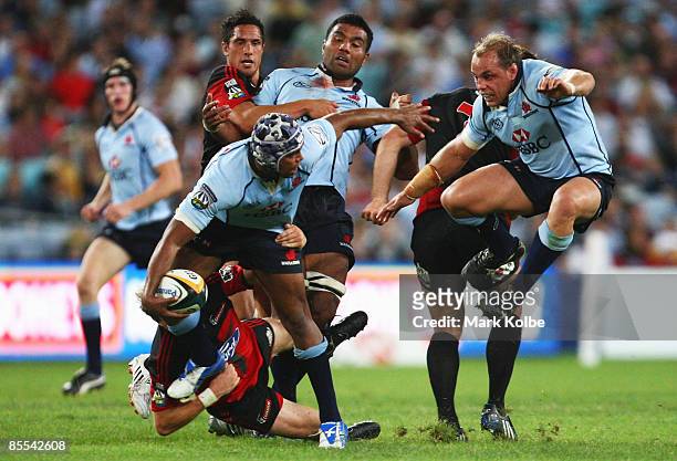 Kurtley Beale of the Waratahs looks to pass to Phil Waugh of the Waratahs during the round six Super 14 match between the Waratahs and the Crusaders...