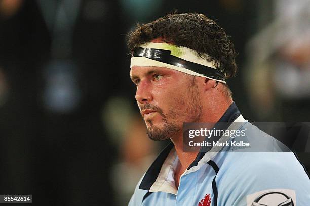 Dejected looking Al Baxter of the Waratahs watches on from the bench after injuring his leg during the round six Super 14 match between the Waratahs...