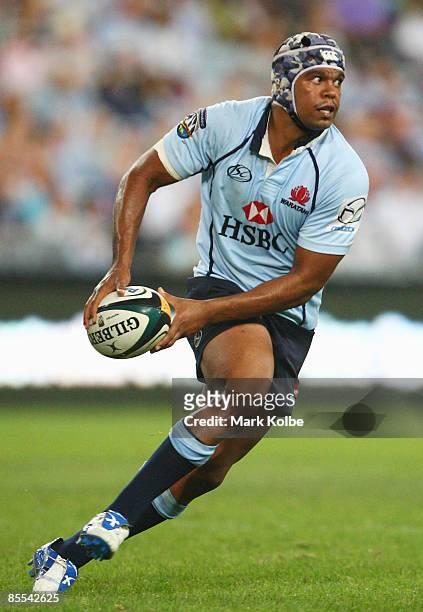 Kurtley Beale of the Waratahs looks to pass during the round six Super 14 match between the Waratahs and the Crusaders at ANZ Stadium on March 21,...