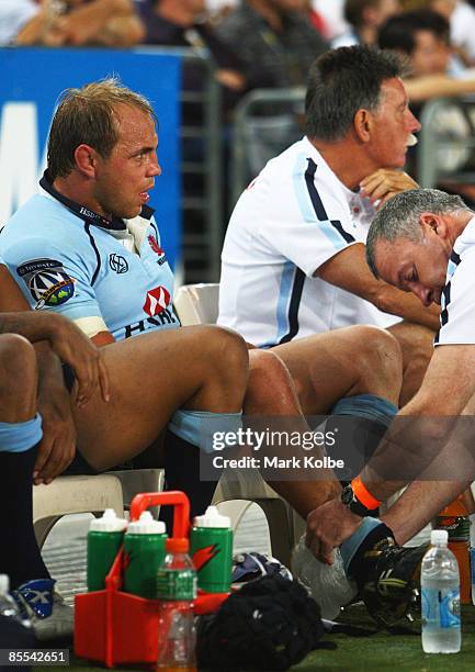 Phil Waugh of the Waratahs watches on from the bench after injuring his leg during the round six Super 14 match between the Waratahs and the...