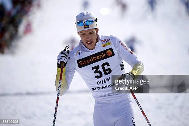 Sweden's Markus Hellner celebrates after crossing the finish line to place second in the men's 10+10 km at the Cross Country skiing world cup in...