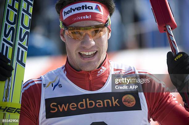 Switzerland�s Dario Cologna celebrates after winning the men's 10+10 km at the Cross Country skiing world cup in Falun, on March 21, 2009....