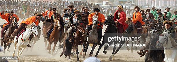 Afghan horsemen compete over the carcass of headless cattle during Afghanistan's traditional game of Buzkashi in the northern town of Mazar-i-Sharif...