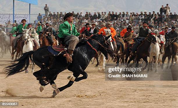 Afghan horsemen compete over the carcass of headless cattle during Afghanistan's traditional game of Buzkashi in the northern town of Mazar-i-Sharif...