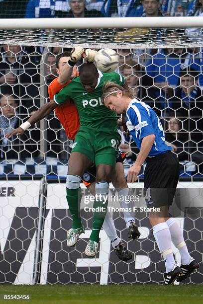 Dennis Eilhoff of Bielefeld, Grafite of Wolfsburg and Nico Herzig of Bielefeld head for the ball during the Bundesliga match between Arminia...