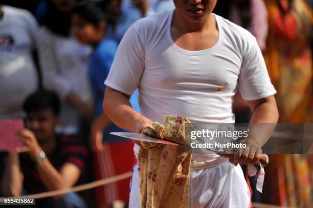 Nepalese devotees cleans KHUKURI as after slaughter a goat on the occasion of Navami, ninth day of Dashain Festival at Basantapur Durbar Square,...