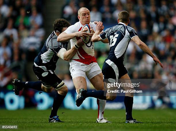 Chris Paterson of Scotland tackles Phil Vickery of England during the RBS 6 Nations Championship match between England and Scotland at Twickenham on...