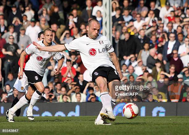 Fulham's English player Danny Murphy scores from the penalty spot against Manchester United during their Premier League football match at Craven...