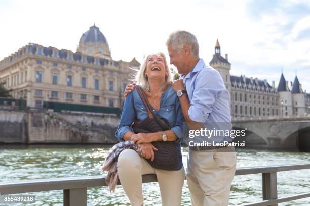 seniors taking a break in paris relaxing on the seine river - tourism in paris stock pictures, royalty-free photos & images