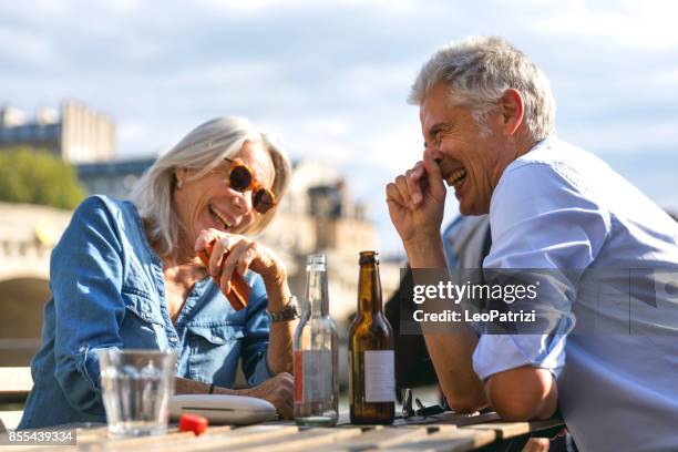 remembering our great experiences - seniors having fun drinking - french cafe stock pictures, royalty-free photos & images