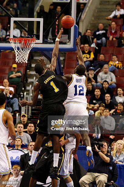 Alfred Aboya of the UCLA Bruins shoots against Larry Sanders of the VCU Rams during the first round of the NCAA Division I Men's Basketball...