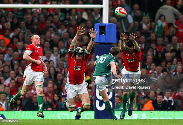 Ronan O'Gara of Ireland kicks the match and Grandslam winning drop goal as the Welsh defence close in during the RBS 6 Nations Championship match...