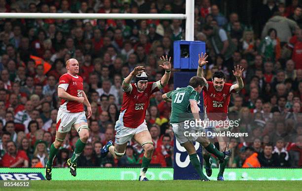 Ronan O'Gara of Ireland kicks the match and Grandslam winning drop goal as the Welsh defence close in during the RBS 6 Nations Championship match...