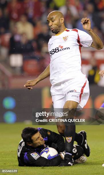 Sevilla's Frederic Kanoute vies with Valladolid's goalkeeper Justo Villar during their Spanish league football match at Sanchez Pizjuan stadium in...