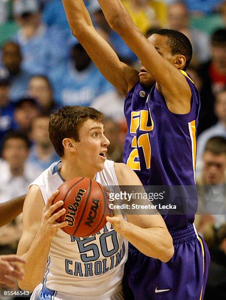 Chris Johnson of the Louisiana State University Tigers defends against Tyler Hansbrough of the North Carolina Tar Heels during the second round of...