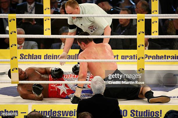 Vitali Klitschko of the Ukraine and Juan Carlos Gomez of Cuba fall to the canvas during their WBC World Championship Heavyweight at the...