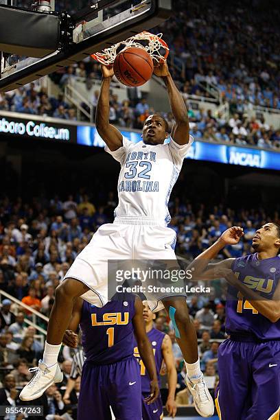 Ed Davis of the North Carolina Tar Heels dunks against Garrett Temple of the Louisiana State University Tigers during the second round of the NCAA...