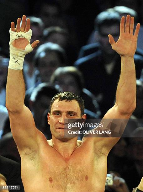 Ukrainian boxer Vitali Klitschko celebrates after defeating challenger Juan Carlos Gomez of Cuba during their WBC heavyweight title fight on March...