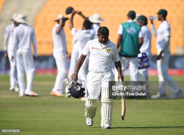 Rangana Herath of Sri Lanka leaves the field after being dismissed by Yasir Shah of Pakistan during Day Two of the First Test between Pakistan and...