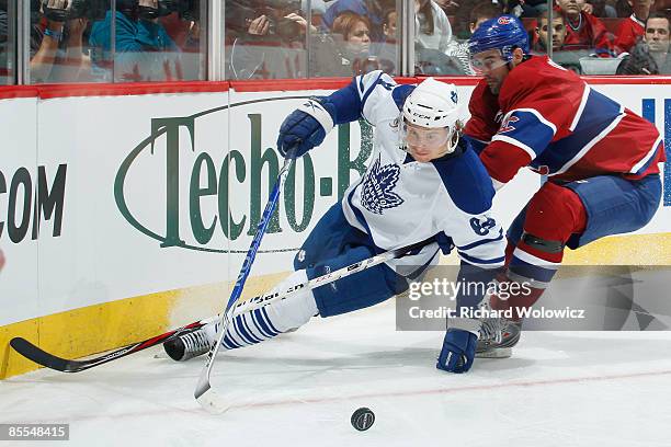 Ryan O'Byrne of the Montreal Canadiens and Mikhail Grabovski of the Toronto Maple Leafs chase the puck into the corner during the NHL game at the...