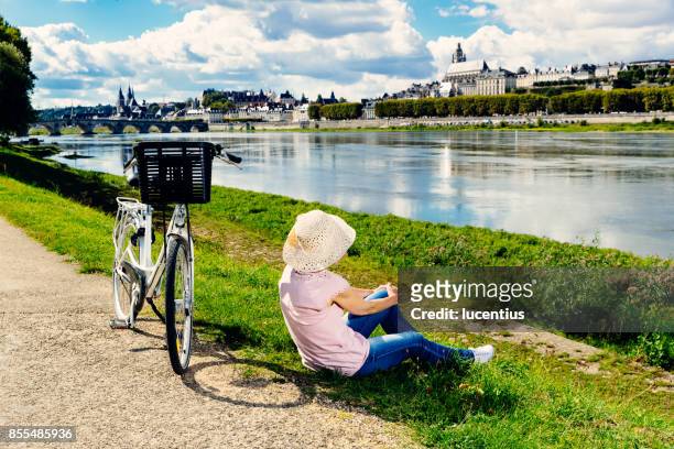 senior woman cycling loire valley, france - cycling loire valley stock pictures, royalty-free photos & images