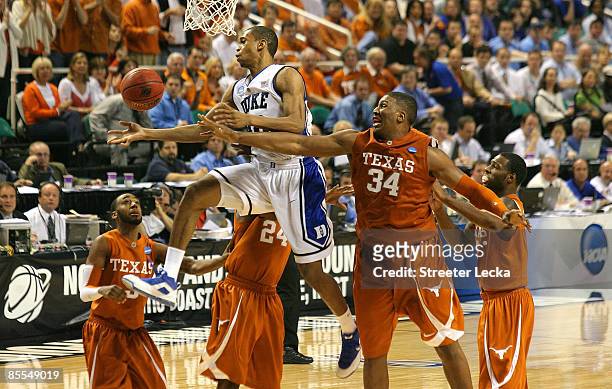 Lance Thomas of the Duke Blue Devils battles for a rebound against Dexter Pittman of the Texas Longhorns during the second round of the NCAA Division...