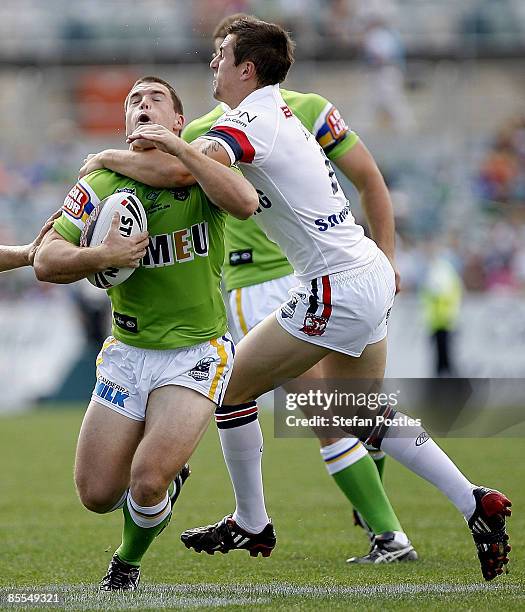 David Milne of the Raiders is tackled by Mitchell Pearce of the Roosters during the round two NRL match between the Canberra Raiders and the Sydney...