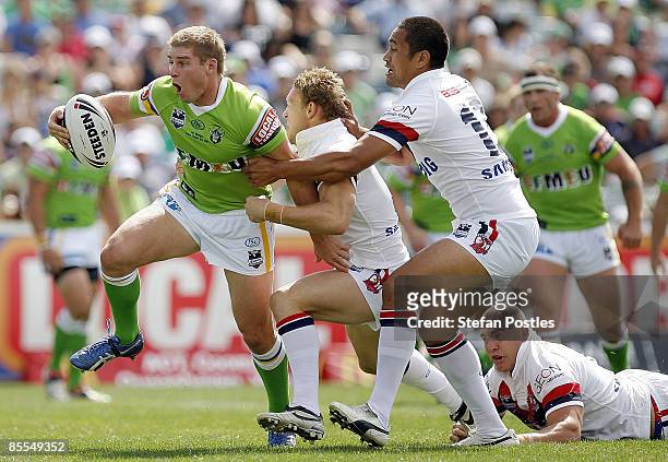 Glen Buttriss of the Raiders slips out of a tackle during the round two NRL match between the Canberra Raiders and the Sydney Roosters at Canberra...