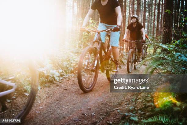 women mountain biking team - trail ride stock pictures, royalty-free photos & images