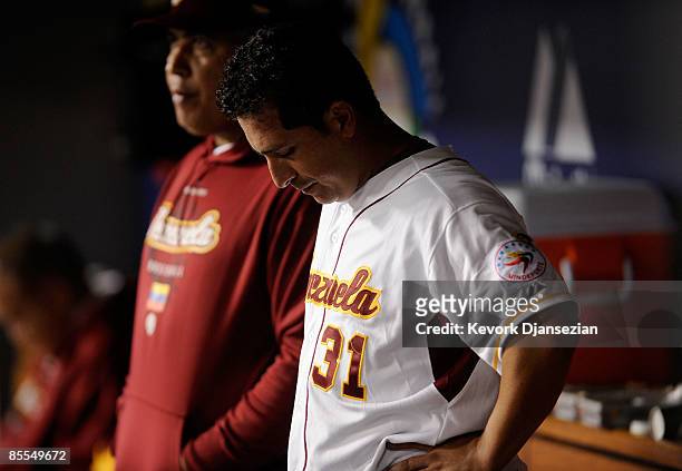 Victor Zambrano of Venezuela and coach Andres Galarraga look on from the dugout during the semifinal game of the 2009 World Baseball Classic against...