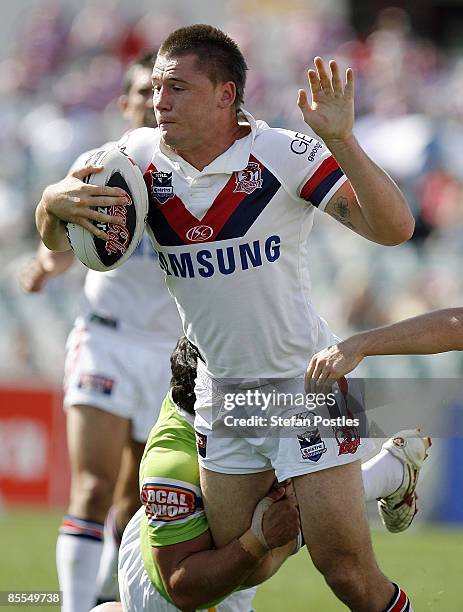 Shaun Kenny-Dowall of the Roosters is tackled during the round two NRL match between the Canberra Raiders and the Sydney Roosters at Canberra Stadium...