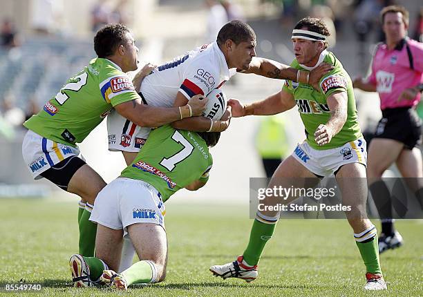 Willie Mason of the Roosters is tackled during the round two NRL match between the Canberra Raiders and the Sydney Roosters at Canberra Stadium on...