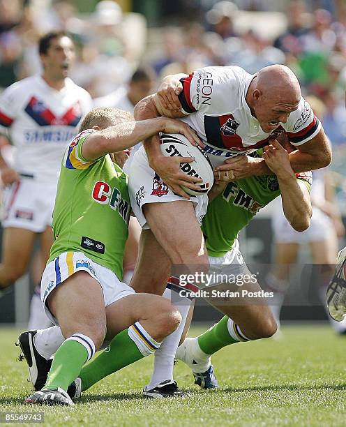 Craig Fitzgibbon of the Roosters is tackled during the round two NRL match between the Canberra Raiders and the Sydney Roosters at Canberra Stadium...