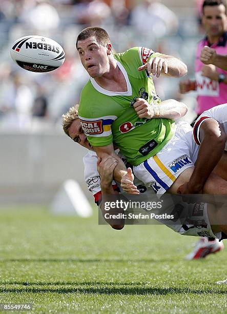 David Milne of the Roosters off loads the ball during the round two NRL match between the Canberra Raiders and the Sydney Roosters at Canberra...