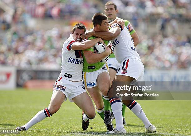 David Milne of the Raiders is tackled during the round two NRL match between the Canberra Raiders and the Sydney Roosters at Canberra Stadium on...