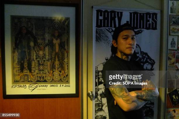 Gary Jones is pictured while posing inside his shop. Gary Jones is one of the Kadazan talented tattoo artist from Borneo. He had almost 10 years...