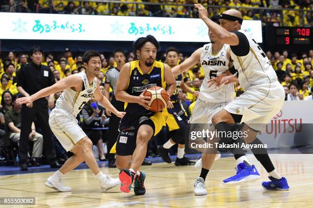 Yuta Tabuse of the Tochigi Brex handles the ball under pressure from the SeaHorse Mikawa defense during the B.League game between Tochigi Brex and...