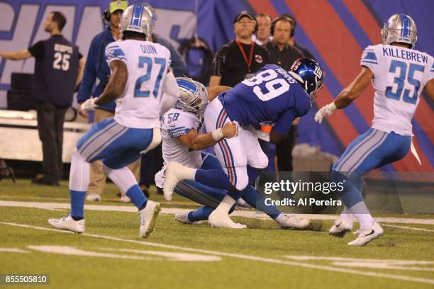 Linebacker Paul Worrilow and Safety Miles Killebrew of the Detroit Lions make a stop against the New York Giants on September 18, 2017 at MetLife...