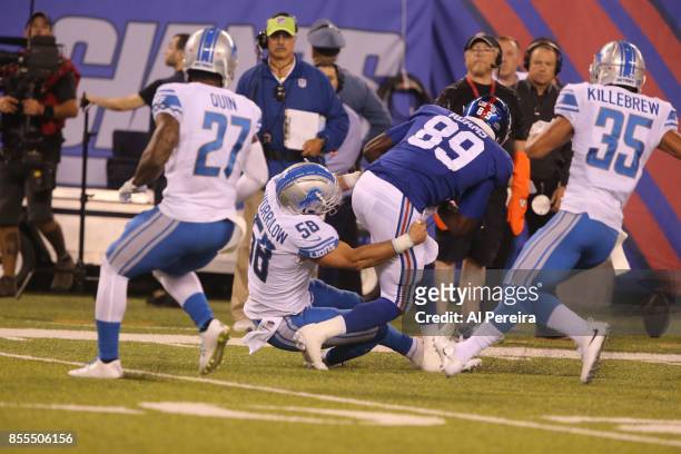 Linebacker Paul Worrilow and Safety Miles Killebrew of the Detroit Lions make a stop against the New York Giants on September 18, 2017 at MetLife...