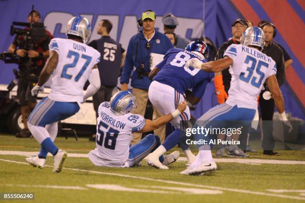 Linebacker Paul Worrilow and Safety Miles Killebrew of the Detroit Lions make a stop against the New York Giants on September 18, 2017 at MetLife...