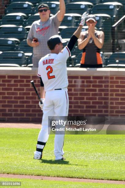 Fans salute J.J. Hardy of the Baltimore Orioles during a baseball game against the Tampa Bay Rays at Oriole Park at Camden Yards on September 24,...