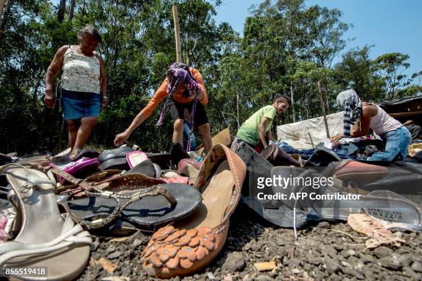 Members of the Workers Without a Roof Movement choose among clothing and footwear donated to the Povo sem Medo camp in which live about 7,000...
