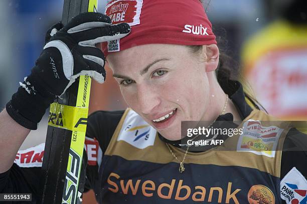 Poland's Justyna Kowalczyk celebrates winning the women's 10 km pursuit during the Cross Country skiing world cup in Falun on March 22, 2009....