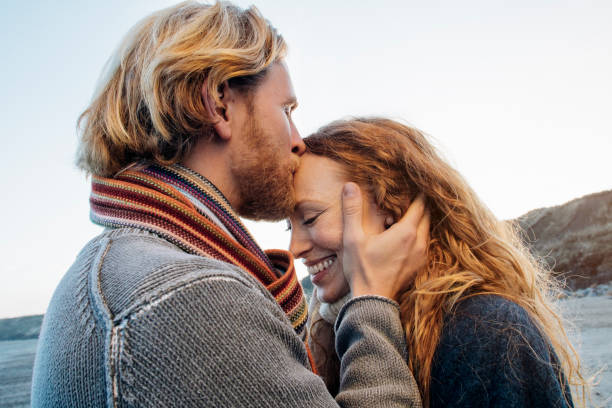 romantic day out on the beach - lovely man and women stock pictures, royalty-free photos & images